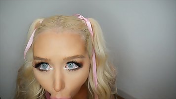 Busty blonde with blue eyes sucks a rubber dick in front of the camera